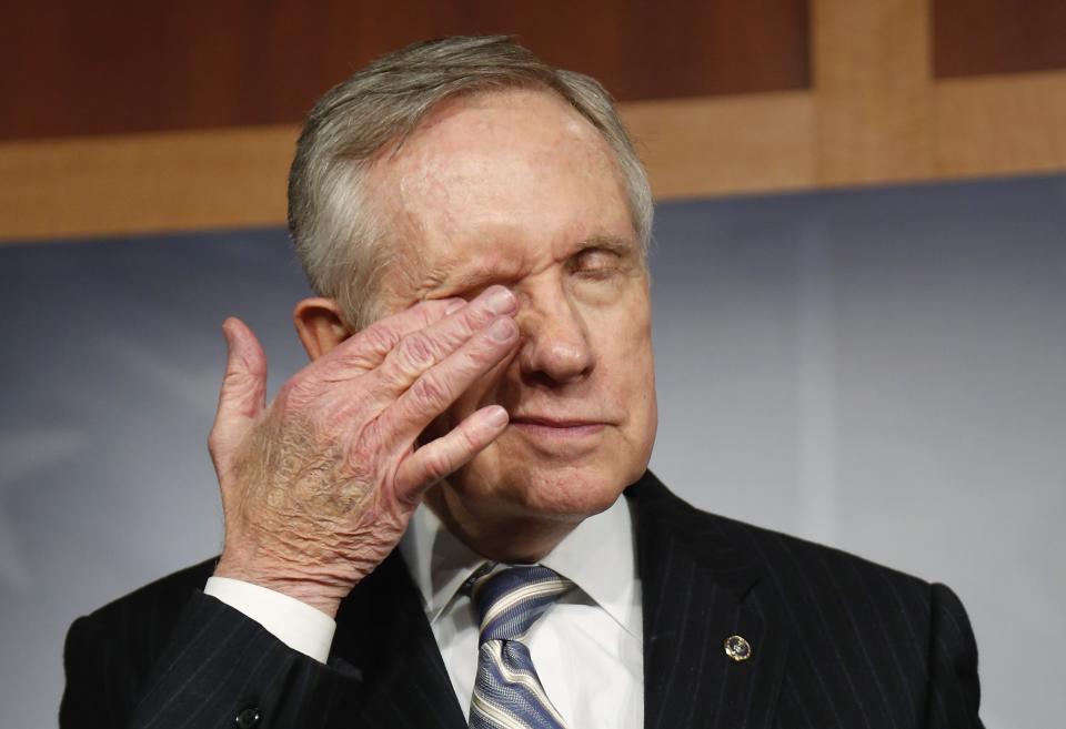 U.S. Senate Majority Leader Harry Reid (D-NV) rubs his eyes during a news conference after a bipartisan passage of a budget and debt legislation at the U.S. Capitol in Washington, October 16, 2013. The U.S. Senate approved a deal on Wednesday to end a political crisis that partially shut down the federal government and brought the world's biggest economy to the edge of a debt default that could have threatened financial calamity. REUTERS/Jonathan Ernst (UNITED STATES - Tags: POLITICS BUSINESS)