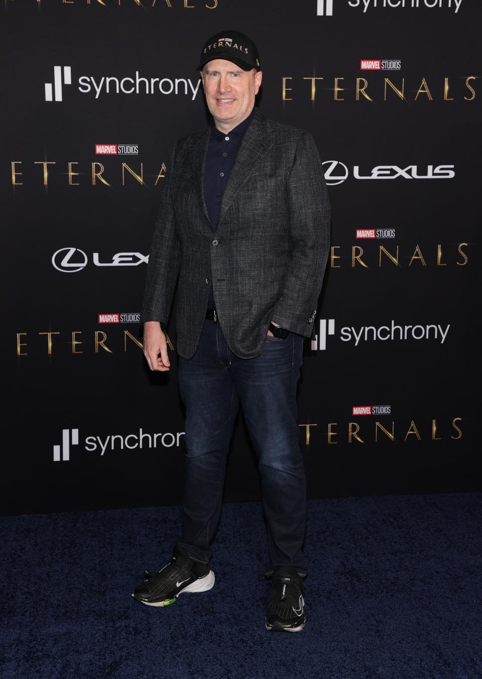 Kevin Feige in a baseball cap, dark jacket, and jeans.