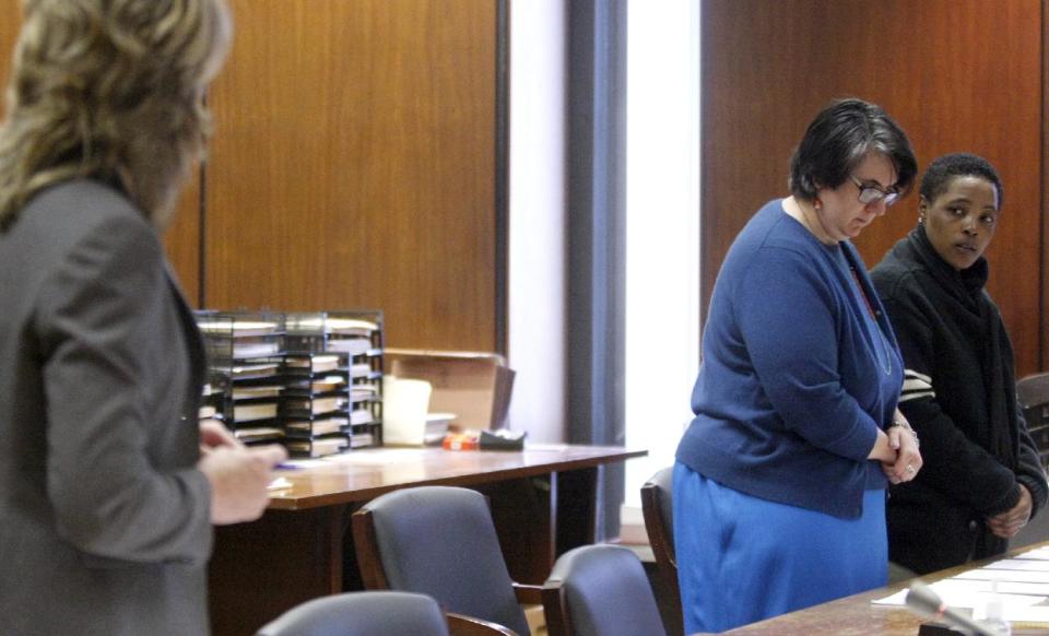 Assistant Prosecutor Michele Miller, left, questions Haniyyah Barnes, far right, during a hearing in Superior Court, Tuesday, April 29, 2014, in Newark, N.J., with defense attorney Susan Freedman standing center. The Star-Ledger of Newark reports that Barnes pleaded guilty to breaking into her neighbor's home, grabbing the 2-year-old Shih Tzu and throwing the dog into oncoming traffic in August 2011, where she was struck by a vehicle and killed. Barnes will be sentenced July 14. (AP Photo/The Star-Ledger, Patti Sapone, Pool)