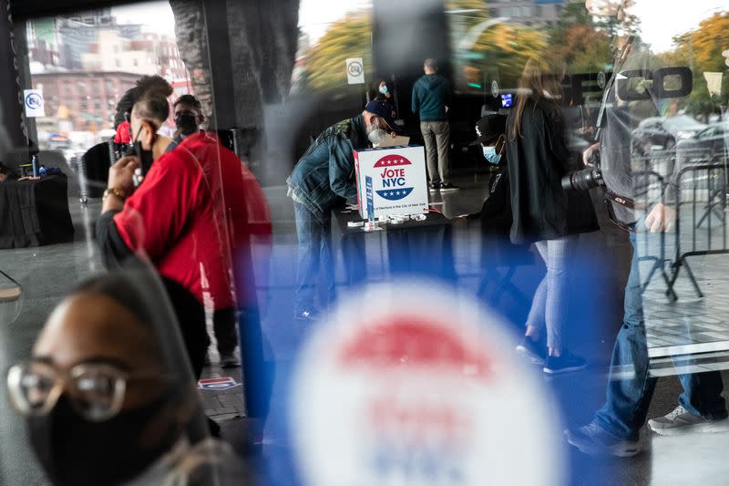 Voters line up to cast ballots on the first day of early voting in New York