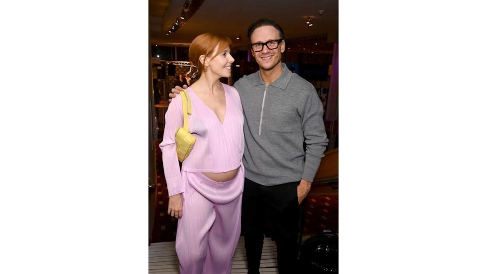 Stacey Dooley in pink stood with Kevin Clifton in a grey jumper and trousers