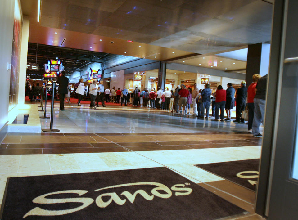 FILE - In this file photo from Friday, May 22, 2009, patrons stand in line to enter the Sands Casino Bethlehem when it opens its doors to the public for the first time, in Bethlehem, Pa. A generation ago, this town was booming thanks to a manufacturing behemoth that helped build the New York City skyline, Panama Canal, battleships and countless miles of railway. Now, more than a decade after Bethlehem Steel went bankrupt, the city is reinvigorating itself through a different industry: casino gambling. (AP Photo/ Rick Smith, File)