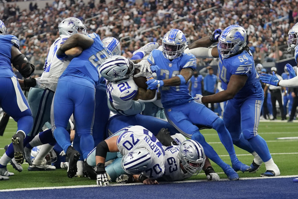 Dallas Cowboys running back Ezekiel Elliott (21) breaks through the Detroit Lions defense for a touchdown during the second half of an NFL football game, Sunday, Oct. 23, 2022, in Arlington, Texas. (AP Photo/Tony Gutierrez)