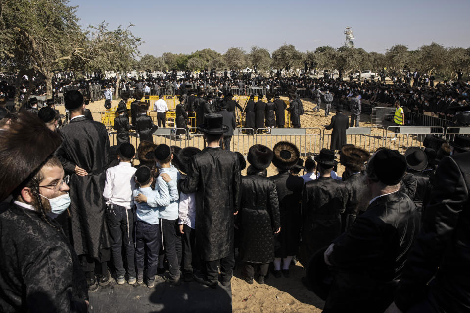 Large numbers of ultra-Orthodox Jews gather for the funeral for Rabbi Mordechai Leifer, in the port city of Ashdod, Israel, Monday, Oct. 5, 2020. After a revered ultra-Orthodox rabbi died this week, Israeli police thought they had worked out an arrangement with his followers to allow a small but dignified funeral that would conform with public health guidelines under the current coronavirus lockdown. The repeated violations by segments of the ultra-Orthodox population have confounded public health experts and tested Prime Minister Benjamin Netanyahu's longstanding political alliance with religious leaders. (AP Photo/Tsafrir Abayov)