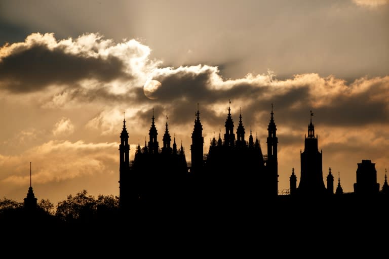 The sun sets behind the Houses of Parliament in London