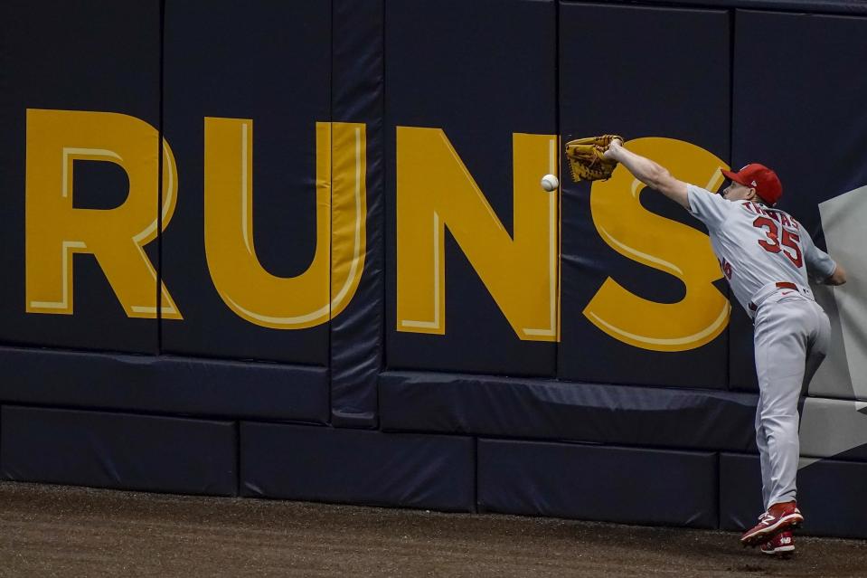 St. Louis Cardinals' Lane Thomas can't catch a ball hit by Milwaukee Brewers' Jedd Gyorko during the fifth inning of a baseball game Tuesday, Sept. 15, 2020, in Milwaukee. (AP Photo/Morry Gash)