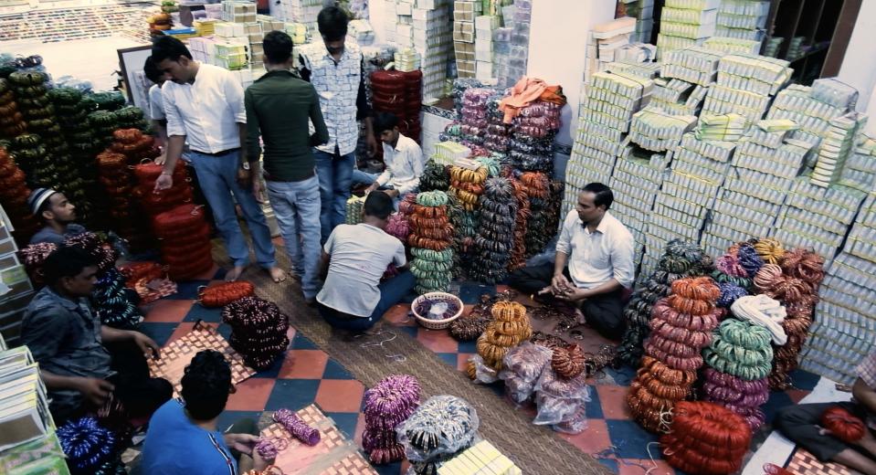 Men buy and sell bangles at a shop in Firozabad