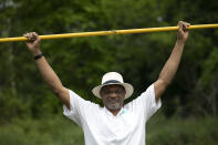 Benn Fields holds a high jump crossbar over his head, Friday, July 31, 2020, at his home in Salisbury Mills, N.Y. Fields will forever be known as a U.S. Olympian, he will also always wonder about what might have been had the U.S. government not spearheaded a boycott of the 1980 Olympic Games in Moscow.(AP Photo/Mark Lennihan)