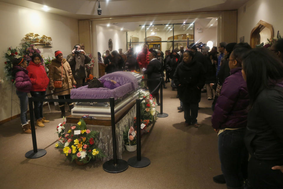 FILE - In this Feb. 8, 2013 file photo, mourners view the remains of 15-year-old Hadiya Pendleton at the Calahan Funeral Home in Chicago. Hadiya was shot and killed Jan. 29, 2013, in a park during a gang dispute she had nothing to do with about a mile from President Barack Obama's Chicago home. A year ago, the city’s bloodiest January in more than a decade had just ended. Since then, the number of homicides and other violent crimes that turned Chicago into a national symbol of gun violence have fallen sharply after the city and police changed strategies. (AP Photo/Charles Rex Arbogast, Pool)