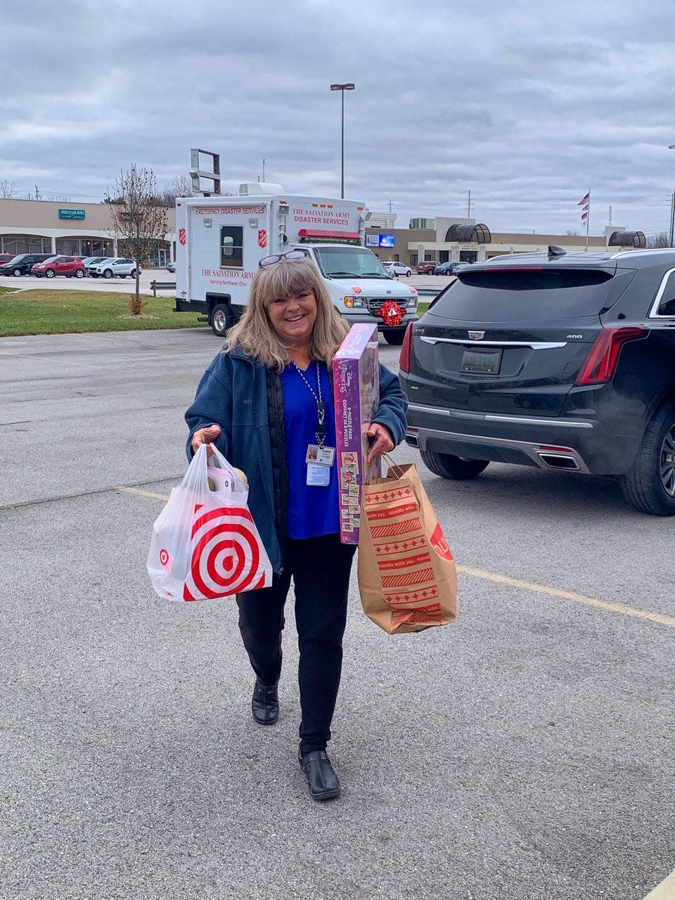 Sherry Hower, a Staff Specialist with Davis-Besse Nuclear Power Station, carries toys into the Ottawa County Salvation Army Service Center.