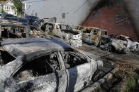 A parking lot filled with scorched cars is seen Saturday, May 30, 2020, after a night of fires and looting in Minneapolis. Protests continued following the death of George Floyd, who died after being restrained by Minneapolis police officers on Memorial Day. (AP Photo/Julio Cortez)