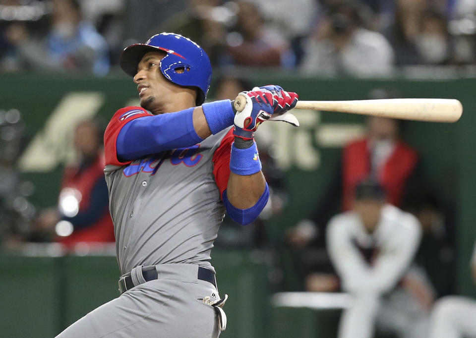 Cuba's Yurisbel Gracial watches the flight of his two-run home-run off Japan's starter Tomoyuki Sugano during the second inning of their second round game at the World Baseball Classic at Tokyo Dome in Tokyo, Tuesday, March 14, 2017. (AP Photo/Toru Takahashi)