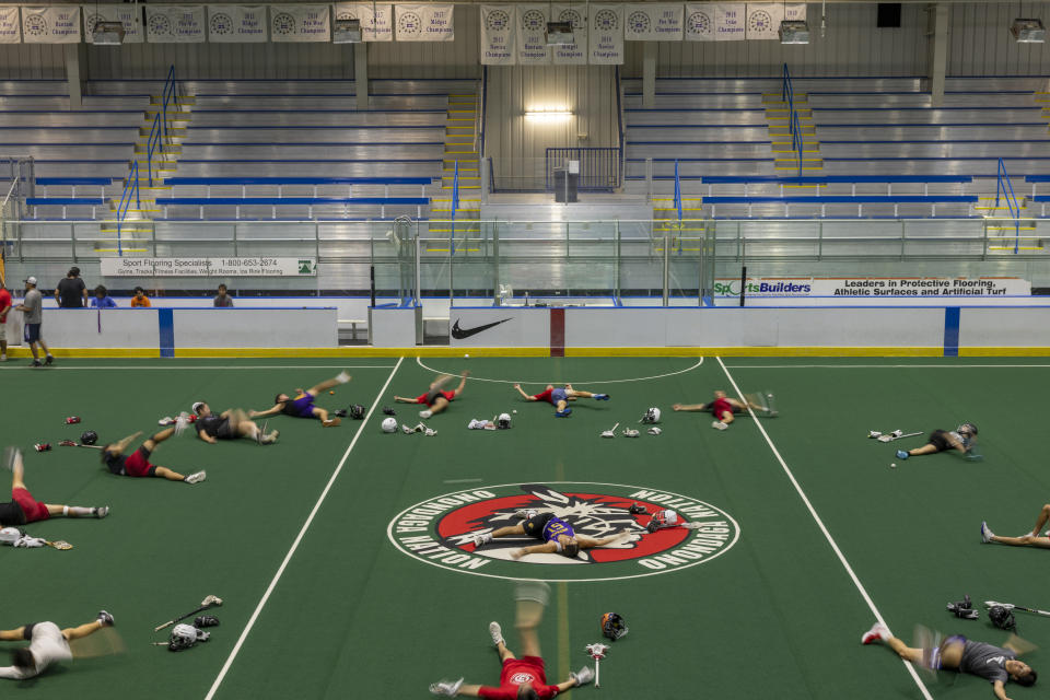 Athletes on the Onondaga RedHawks Lacrosse team warm up inside of the Onondaga Nation Arena before practice, Thursday, Aug. 3, 2023, in central New York. (AP Photo/Lauren Petracca)