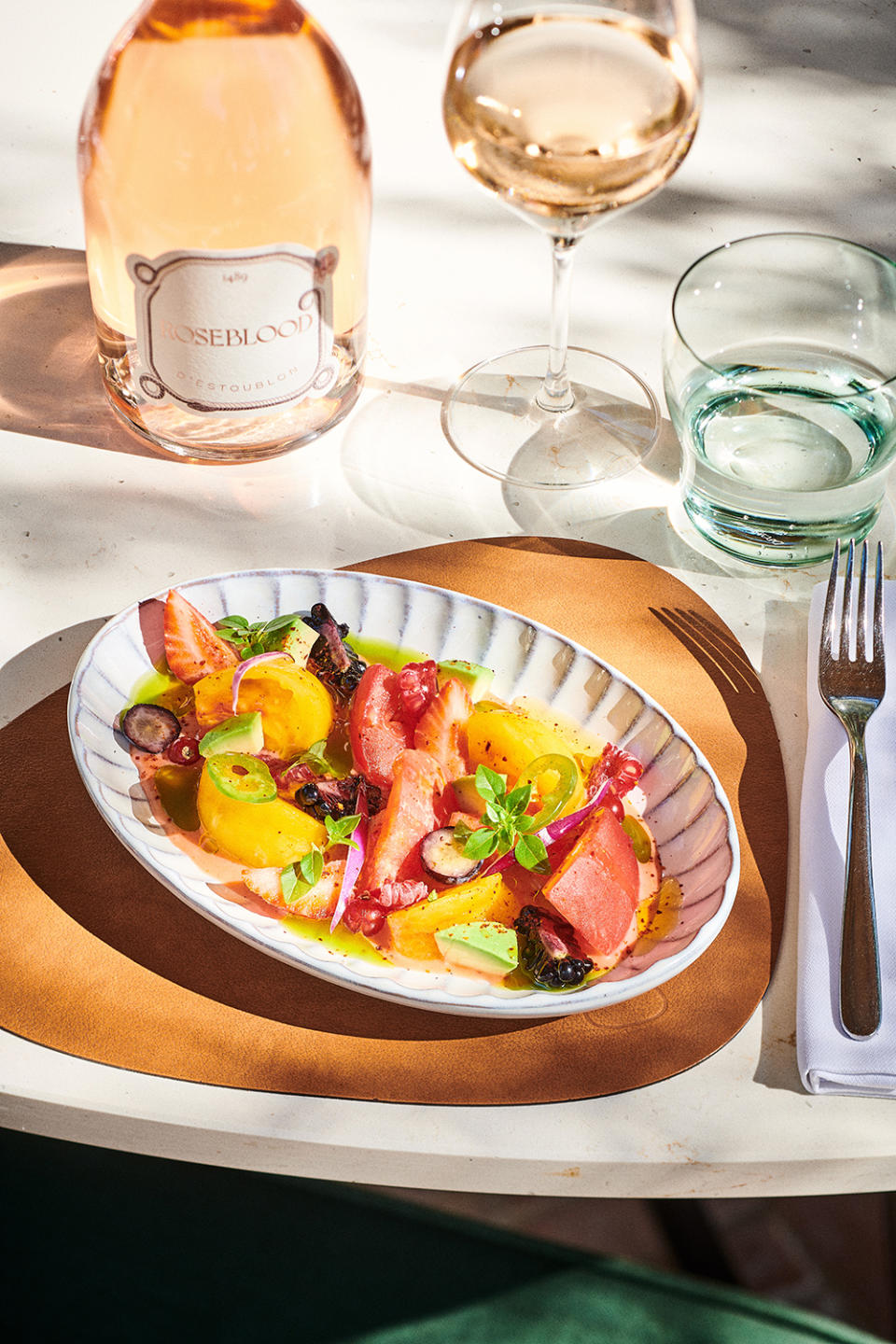 An heirloom-tomato salad alongside the estate’s Roseblood rosé.