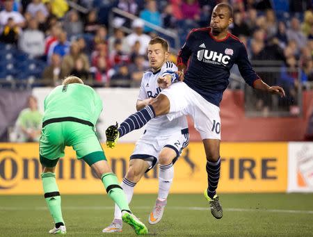 Jun 27, 2015; Foxborough, MA, USA; Vancouver FC defender Jordan Harvey (2) tries to keep New England Revolution forward Teal Bunbury (10) from getting to Vancouver FC goalkeeper David Ousted (1) during the second half of Vancouver FC's 2-1 win over the New England Revolution at Gillette Stadium. Mandatory Credit: Winslow Townson-USA TODAY Sports