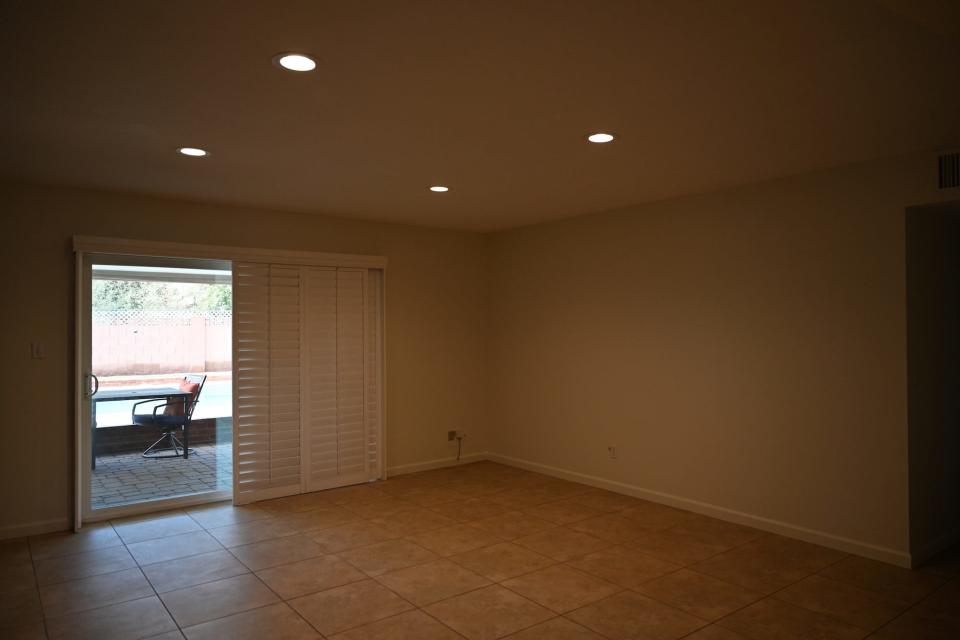 An empty room looking out on a porch.