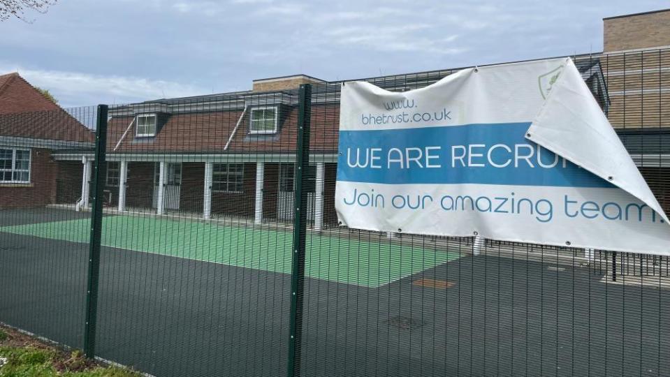 Recruitment banner hanging from fence at Bure Park Specialist Academy