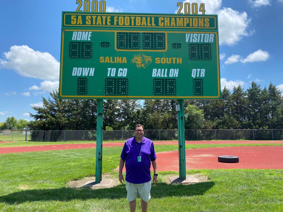 Salina South athletic director Ken Stonebraker stands with the scoreboard at the South High practice field Monday, June 6, 2022. Stonebraker led the Cougars to two state football championships during his tenure as head football coach.