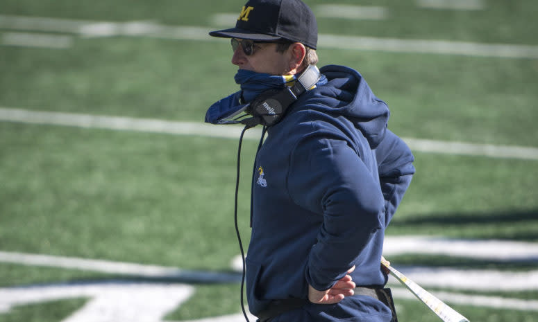 Michigan football head coach Jim Harbaugh on the bench.