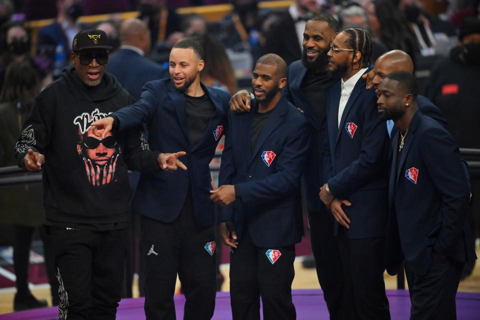 From left, Dennis Rodman, Stephen Curry, Chris Paul, LeBron James, Carmelo Anthony, Ray Allen and Dwyane Wade pose for photos during a halftime ceremony to honor NBA's 75th anniversary team.