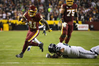 Washington Football Team running back J.D. McKissic (41) break away from Seattle Seahawks defensive tackle Bryan Mone (90) to score a touchdown during the first half of an NFL football game, Monday, Nov. 29, 2021, in Landover, Md. (AP Photo/Nick Wass)