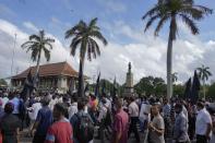 Trade union and civil society activists led by leftists' People Liberation Front shout slogans denouncing president Ranil Wickremesinghe in Colombo, Sri Lanka, Tuesday, Aug. 9, 2022. Hundreds of Sri Lankans Tuesday rallied against a government crackdown and the use of emergency laws against those who protested peacefully against the country’s worst economic crisis in recent memory. (AP Photo/Eranga Jayawardena)