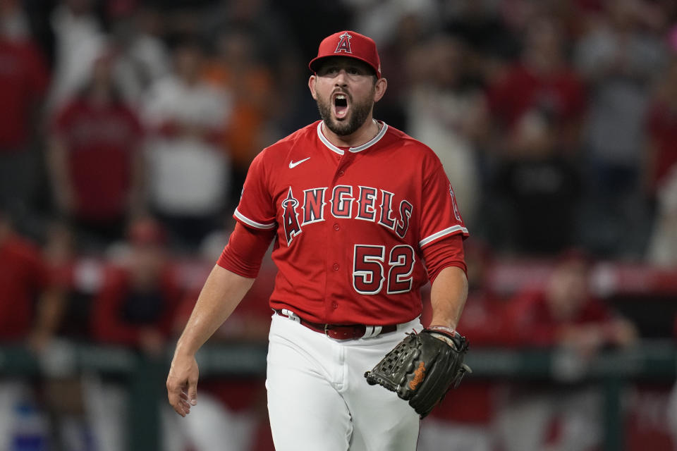 Los Angeles Angels relief pitcher Dominic Leone (52) reacts as C. J. Cron catches a foul ball hit by San Francisco Giants' Luis Matos to end a baseball game in Anaheim, Calif., Tuesday, Aug. 8, 2023. The Angels won 7-5. (AP Photo/Ashley Landis)