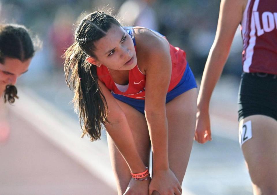 Buchanan’s Elle Lomeli looks to her time on the scoreboard in the first heat of the Girls 1600 M Run at the 2023 CIF California Track & Field State Championship qualifiers Friday, May 26, 2023 in Clovis.