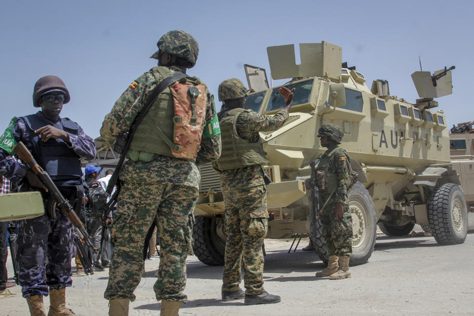 African Union peacekeepers from Uganda provide security as Somali lawmakers arrive to cast their vote in the presidential election, at the Halane military camp in Mogadishu, Somalia Sunday, May 15, 2022. Legislators in Somalia are meeting Sunday to elect the country's president in the capital, Mogadishu, which is under lockdown measures aimed at preventing deadly militant attacks. (AP Photo/Farah Abdi Warsameh)