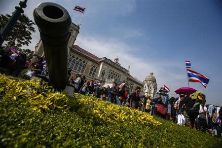 Anti-government protesters wave national flags after they entered the compound of Government House, the site of fierce clashes with police over the last few days, in Bangkok December 3, 2013. REUTERS/Athit Perawongmetha