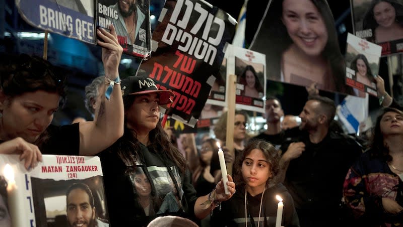 Released hostage Ilana Gritzewsky, center, whose boyfriend, Matan Zangauker, is held hostage by Hamas in the Gaza Strip, stands with Matan's family at a march to call on Israeli Prime Minister Benjamin Netanyahu's government to make a deal to free their loved ones, in Tel Aviv, Israel, Wednesday, May 8, 2024.