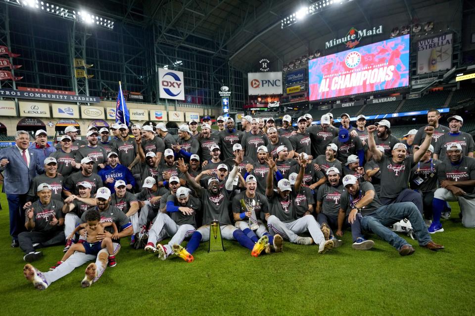 The Texas Rangers pose for a picture after Game 7 of the baseball AL Championship Series against the Houston Astros Monday, Oct. 23, 2023, in Houston. The Rangers won 11-4 to win the series 4-3. (AP Photo/David J. Phillip)