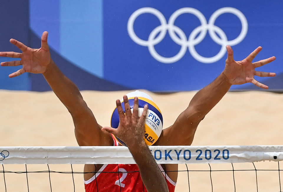 <p>Russia's Oleg Stoyanovskiy (red) blocks a shot by Mexico's Josue Gaston Gaxiola Leyva in the men's preliminary beach volleyball Pool B match between Russia and Mexico at Shiokaze Park.</p>