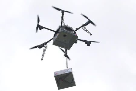 A delivery drone performs a test flight with a Domino's pizza box in Auckland, New Zealand, August 25, 2016. Domino's/Handout via REUTERS