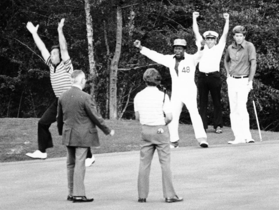 With caddie Jariah Beard cheering, Fuzzy Zoeller holes a putt to win the 1979 Masters.