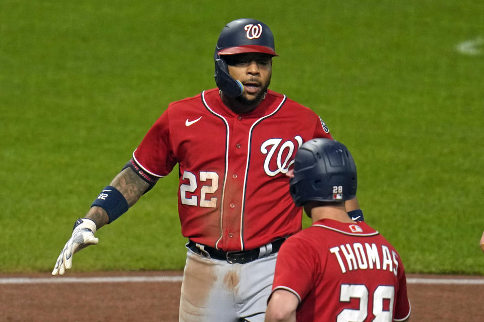 Washington Nationals' Dominic Smith (22) celebrates with Lane Thomas after hitting a two-run home run off Pittsburgh Pirates relief pitcher Quinn Priester during the sixth inning of a baseball game Wednesday, Sept. 13, 2023, in Pittsburgh. (AP Photo/Gene J. Puskar)