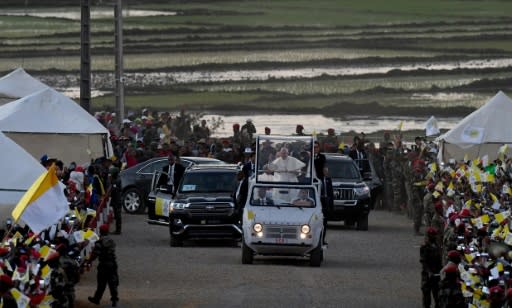 Pope Francis waved to the crowds as he arrived for a vigil with young people in Antananarivo