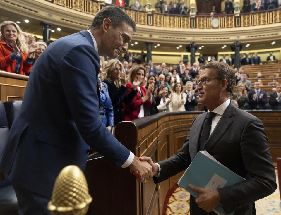 Spain's acting Prime Minister Pedro Sanchez, left, shakes hands with conservative opposition leader Alberto Nunez Feijoo after Sanchez was chosen by a majority of legislators to form a new government after a parliamentary vote at the Spanish Parliament in Madrid, Spain, Thursday, Nov. 16, 2023. Nov. 16, 2023. (Eduardo Parra/Europa Press, Pool Photo via AP) **SPAIN OUT**