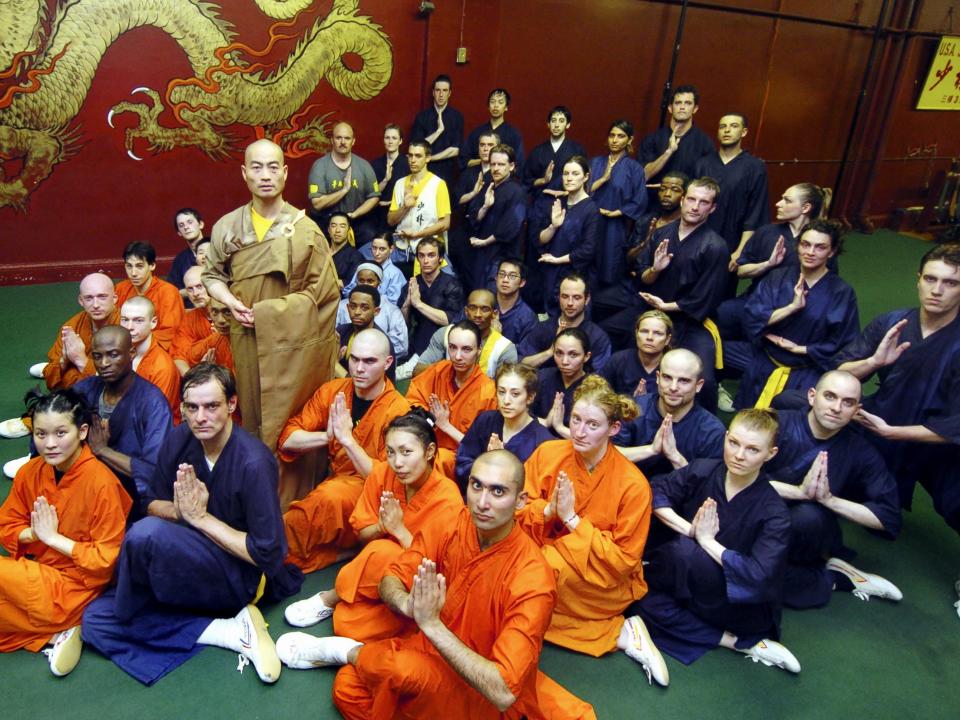 Founder Sifu Shi Yan-Ming (standing), a 34th-generation Shaolin monk, is joined by members of his lower Manhattan USA Shaolin Temple after practice.