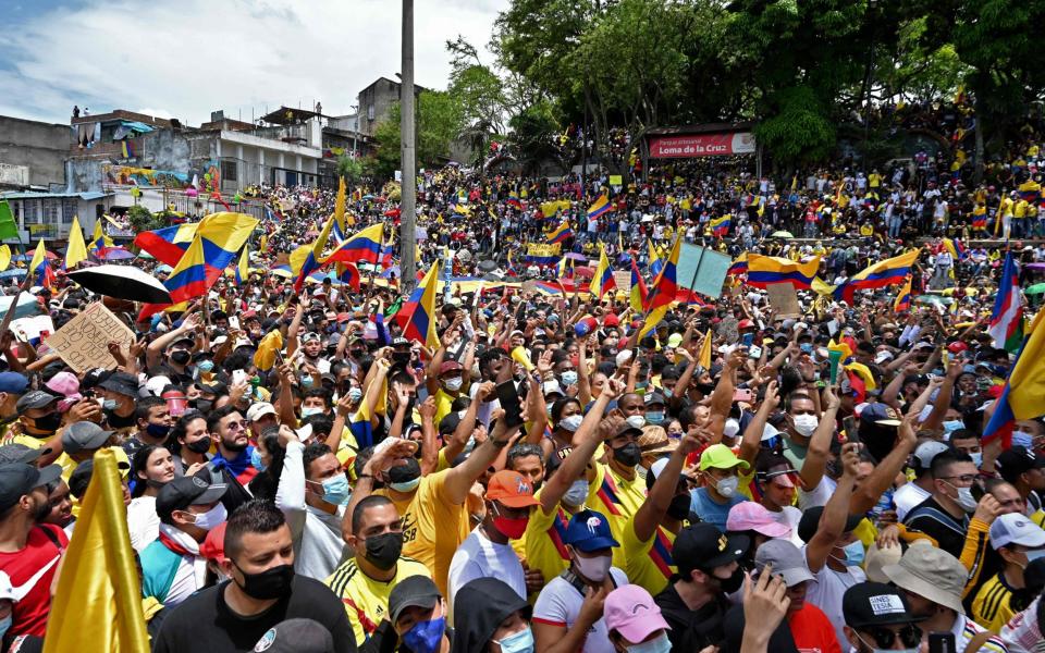 People protest against a tax reform bill they say will leave them poorer as the country battles its deadliest phase yet of the coronavirus pandemic, in Cali, Colombia - LUIS ROBAYO /AFP