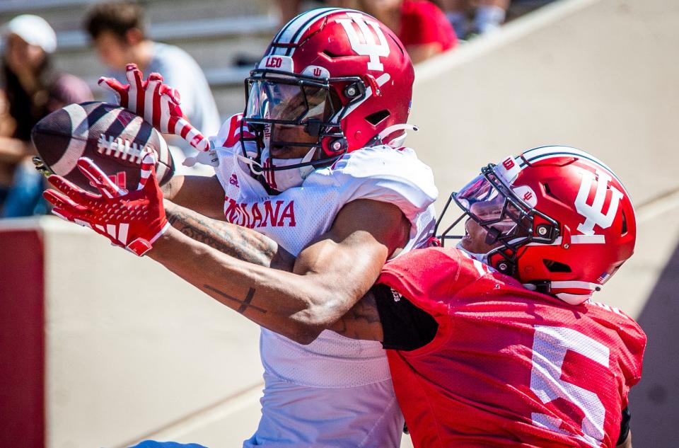Indiana's Kobee Minor (5) stops Donaven McCulley (1) from catching a pass during Indiana football's Spring Football Saturday event at Memorial Stadium on Saturday, April 15, 2203.