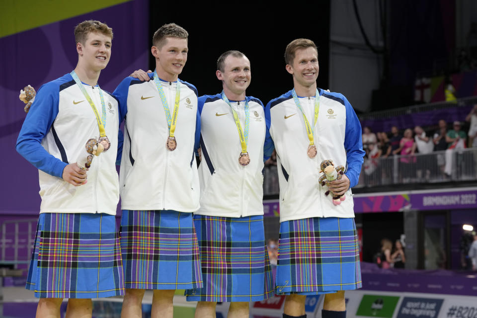 Team Scotland swimmers pose after winning the bronze medal in the Men's 4x100 meters medley relay final during the swimming competition of the Commonwealth Games, at the Sandwell Aquatics Centre in Birmingham, England, Wednesday, Aug. 3, 2022. (AP Photo/Kirsty Wigglesworth)