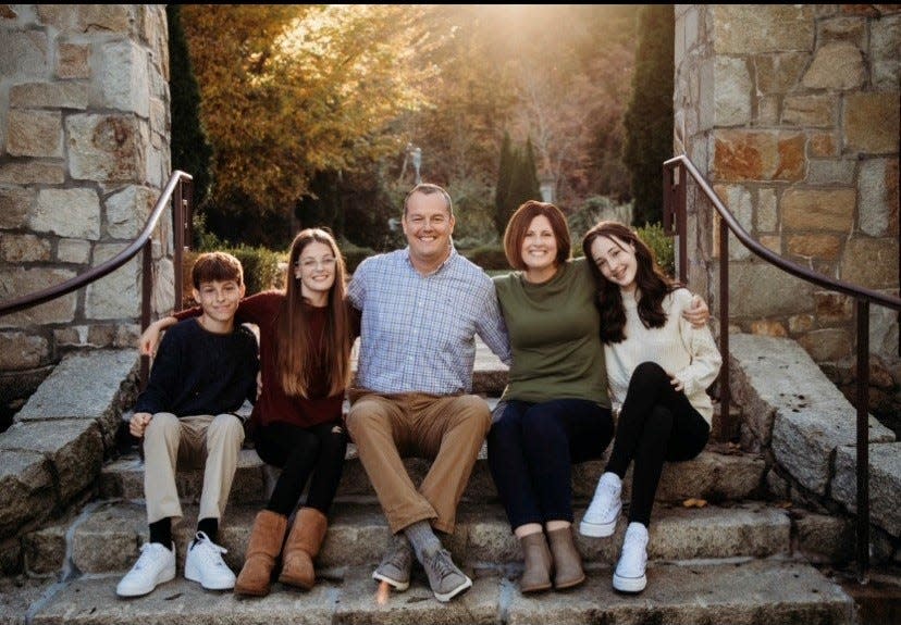 Kenneth Collins, center, sitting with his family, is running for Raynham selectman in the  Annual Town Election on Saturday, April 22, 2023.