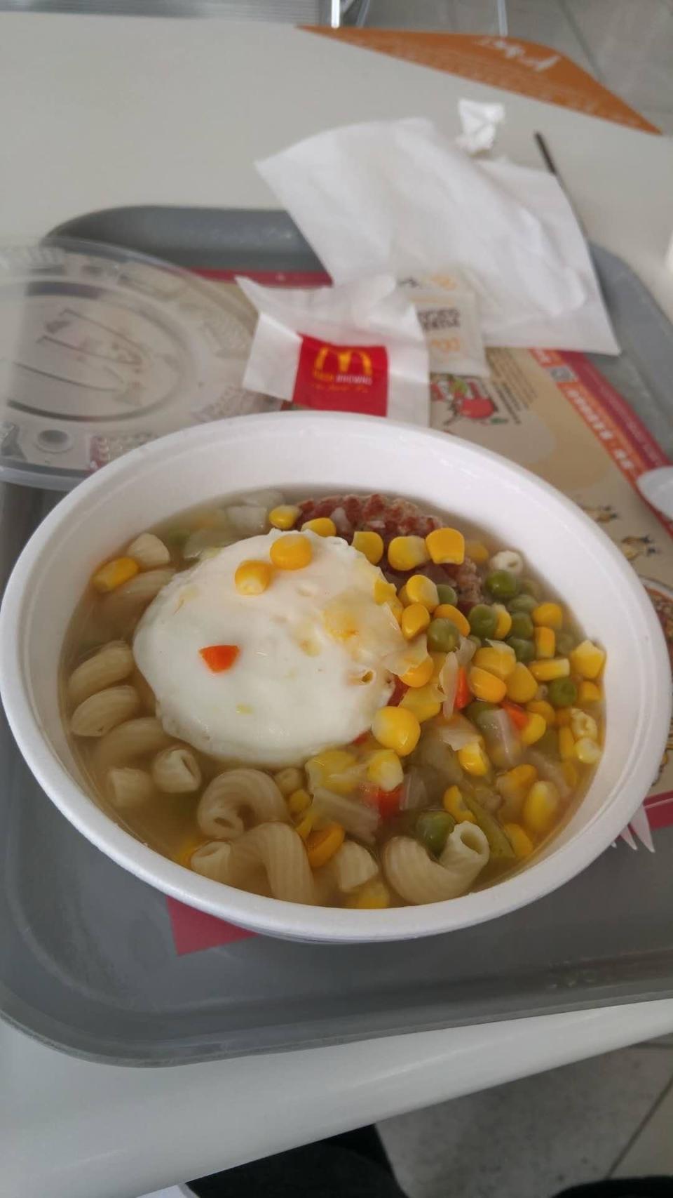 noodle bowl with corn, veggies, pasta, and an egg