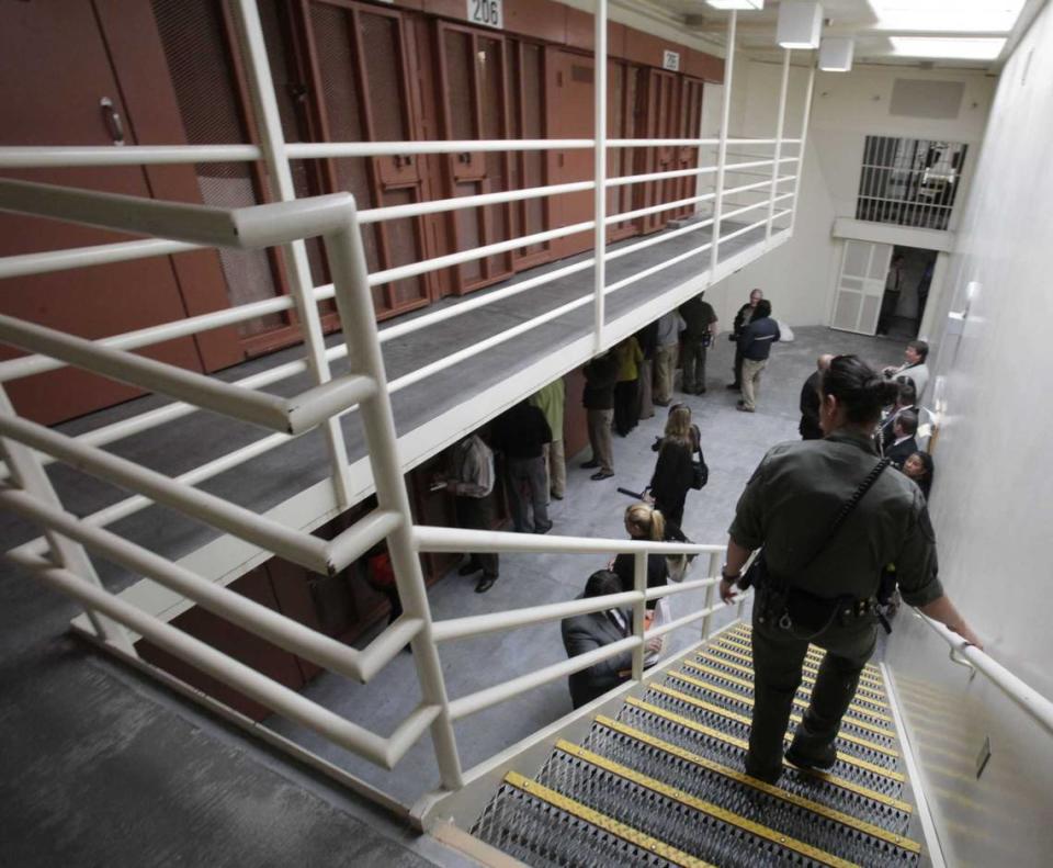 Reporters inspect one of the two-tiered cell pods in the Security Housing Unit, commonly known for solitary confinement, at the Pelican Bay State Prison near Crescent City in 2011. California Gov. Gavin Newsom will change prison solitary confinement rules to give inmates more time outside of cells and in rehabilitation.