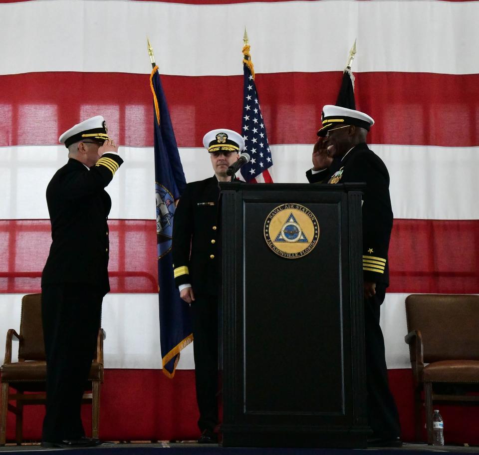Naval Air Station Jacksonville Commanding Officer Capt. Marc Cantu, left, relinquishes command to Executive Officer Capt. Gregory deWindt with Rear Adm. Ian Johnson presiding at center on Feb. 29, 2024.