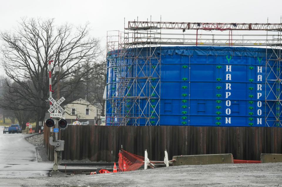 A blue lake storage tank is visible near the railroad tracks in East Palestine Thursday, January 25, 2024. The million galloon storage tank temporarily holds any impacted liquids near the site of the train derailment that happend a year ago.