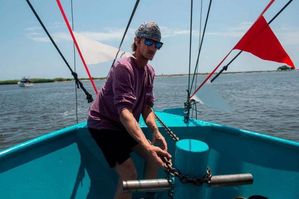 Vincent Bruhl drops anchor on his father-in-law’s boat, My Sons, during the Blessing of the Fleet in Biloxi on Sunday, May 28, 2023.