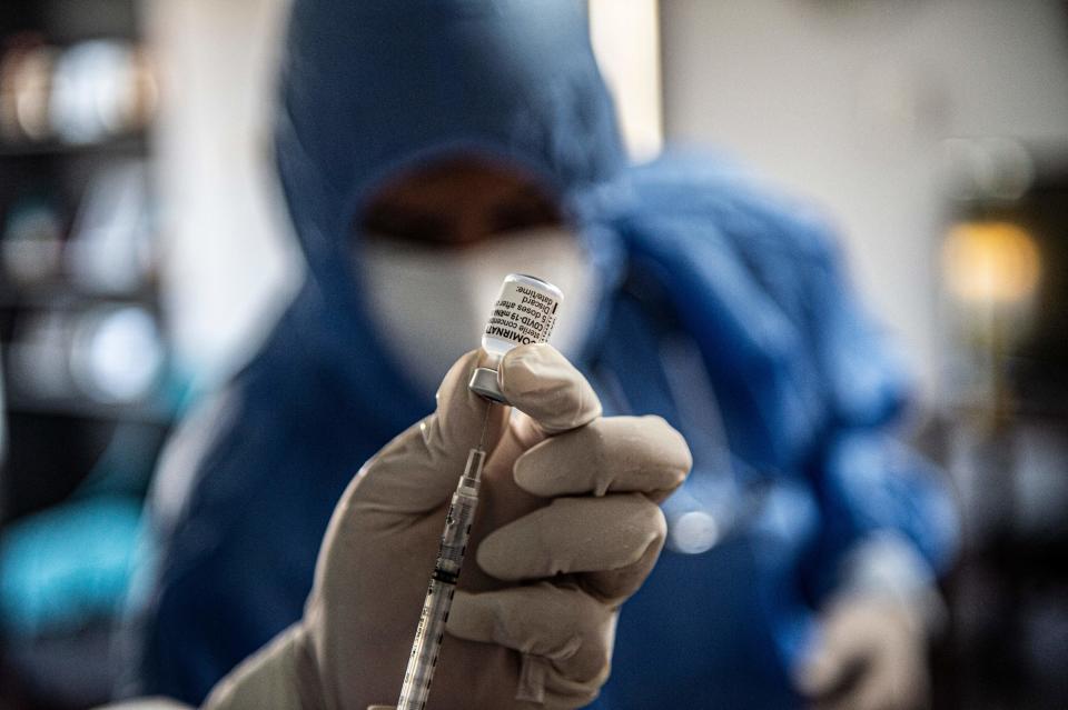 <p>File Image: A health worker prepares a Pfizer-BioNTech vaccine against Covid-19</p> (AFP via Getty Images)