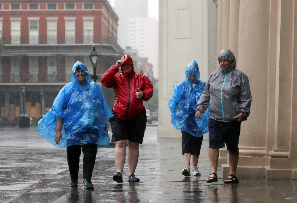 Tourists walk through rain in the French Quarter caused by Hurricane Barry in New Orleans, Louisiana, U.S. July 13, 2019.  REUTERS/Jonathan Bachman